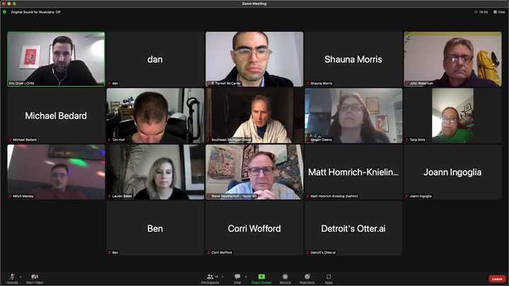 Online meeting application displaying 18 participants, some of whom have video feeds. Eric Dryer (pale skin, black hair, earphones, black shirt) is speaking. Others present are dan, D. Parnell McCarter (pale skin, black hair, glasses, grey shirt), Shauna Morris, John Waterman (pale skin, grey hair, glasses, black sweater), Michael Bedard, Tim Hull (pale skin, black hair, earphones, black shirt), Southeast Michigan Group (pale skin, grey hair, black shirt, grey hoodie), Megan Owens (pale skin, black hair, glasses, black shirt), Taria Sims (darker skin, black hair, glasses, green shirt), Mitch Mantey (pale skin, black hair, glasses, red shirt), Lauren Baker (pale skin, white hair, black shirt), Steve Weatherholt (pale skin, grey hair, glasses, blue shirt), Matt Homrich-Knieling, Joann Ingoglia, Ben, Corri Wofford and Detroit’s Otter.ai. 